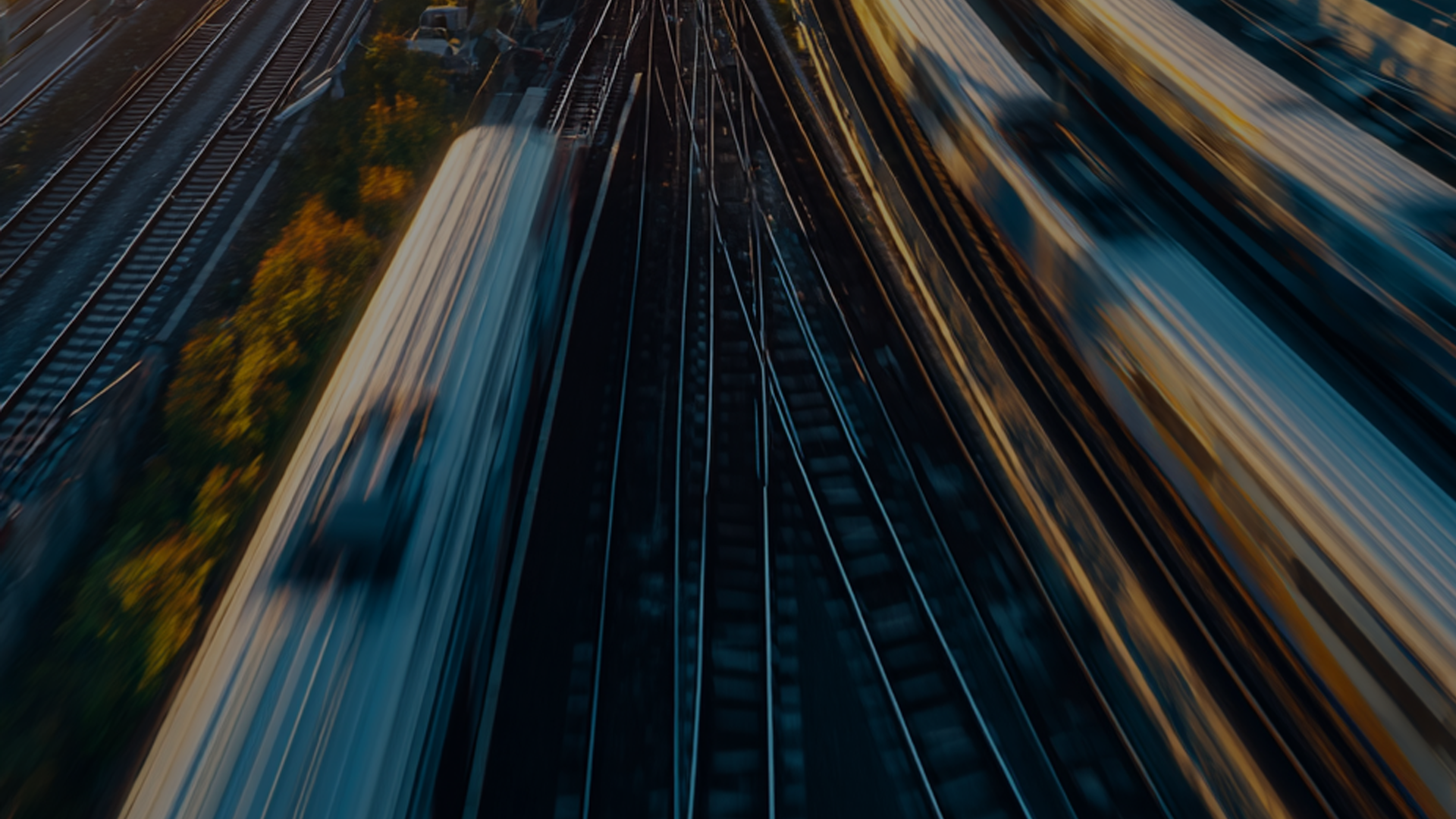 Two women sitting at a modern table talking with a city view behind them.